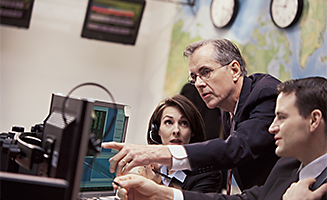 Image of coworkers looking at computer screen