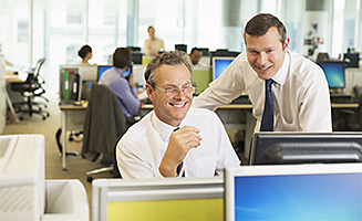 Image of coworkers looking at a computer screen